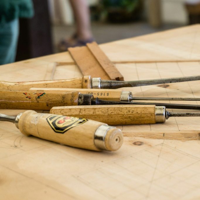 Traditional joinery tools arranged on a timber workbench